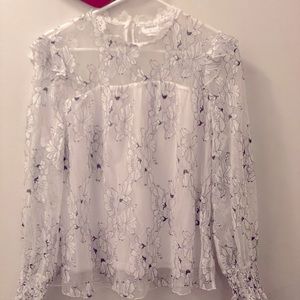 Brand new, unused. Blouse white with flowers details in black on lace.